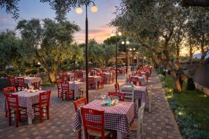 a row of tables with red and white checkered tables at Villa Park Luxury Rooms in Paralio Astros +7 photos