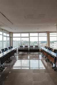 a large room with desks and chairs and windows at Elephanto Hotel LTD in Zanzibar City