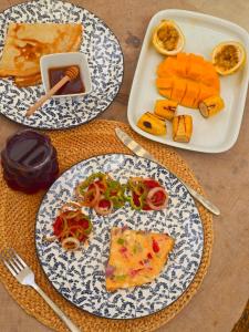 a table with three plates of food on it at Mayssa Villa in Paje
