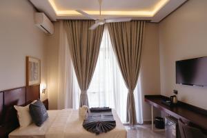 a hotel room with a bed and a large window at Elephanto Hotel LTD in Zanzibar City