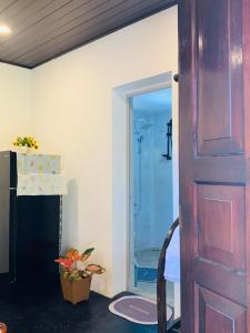 a door leading into a bathroom with a shower at D2 Villa in Tangalle