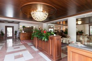 a lobby of a hotel with a chandelier at Hotel Miramonti in Bagno di Romagna