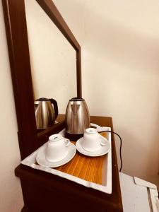 a mirror with two cups and a tea kettle on a table at فندق أوفوك كيندا - ofok kenda hotel in Az Zahrāʼ +23 photos