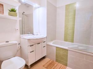 a bathroom with a toilet and a sink and a tub at Maison de vacances près du Mont Ventoux in Aubignan