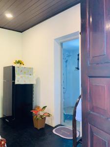 a door leading into a room with a shower at D2 Villa in Tangalle