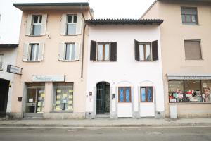 a white building on a street with a store at Casa Dolce Casa in Casorate Primo