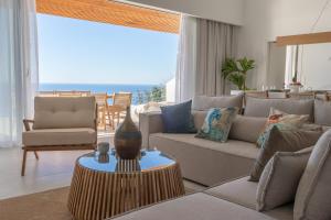 a living room with a couch and a table at Amore Luxury Villas Resort in Athani