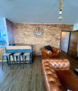 a living room with a couch and a table at COAST HOUSE Havenquartier in Bremerhaven