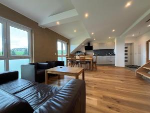 a living room with a couch and a table at Ferienwohnung Weitblick mit Whirlpool in Lasel