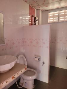 a bathroom with a white toilet and a sink at ลพบุรีทาวน์ Lopburi Town in Lop Buri