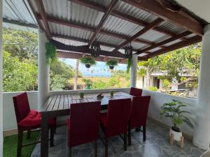 a dining room with a wooden table and chairs at Secret Lanta Guesthouse in Ko Lanta