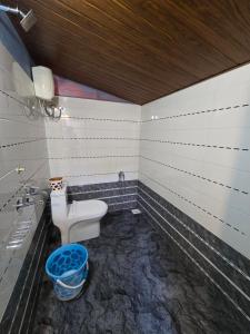 a bathroom with a toilet and a sink at Ayodhya Home stay in Māvalli