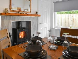 a dining room table with a fireplace and a stove at Carolyn House in Ellington +11 photos