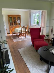 a living room with a red couch and a table at Fehnland in Großefehn 