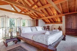 a bedroom with a large bed with a wooden ceiling at Eagle's Rest Villa in Kassiopi +40 photos