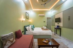 a hotel room with a bed and a couch at Shri Prem Villa in Jaisalmer
