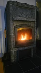a brick fireplace with a fire in it at Outapailakka K18 in Saariselka +18 photos