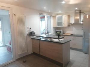 a kitchen with a large island in the middle at l'auberge des trois lieux in Calais