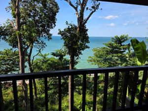 a view of the ocean from a balcony at Relax Bay Beach Resort in Ko Lanta