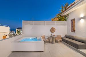 a living room with a hot tub and a couch at Kantouni Lindos ELEGANT APARTMENT in Lindos