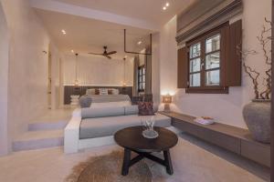 a living room with a bed and a table at Kantouni Lindos ELEGANT APARTMENT in Lindos