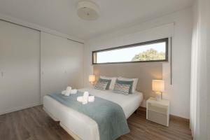 a bedroom with a large bed with a window at Silver Coast Haven in Coto +19 photos
