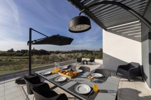 an outdoor dining area with a table and chairs at Silver Coast Haven in Coto