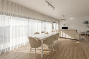 a dining room with a white table and chairs at Silver Coast Haven in Coto