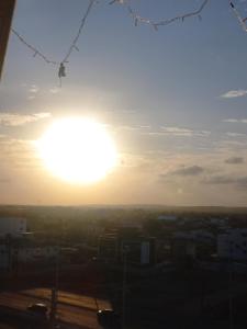 a view of the sun setting over a city at Paraiso Ponta de Campina in Cabedelo