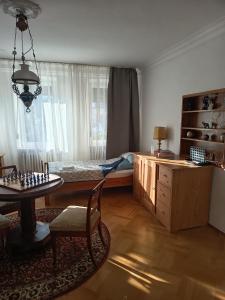 a bedroom with a bed and a chess board on a table at Ferienwohnung Veljanovski Haus der Sonne in Blaufelden