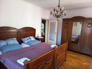 a bedroom with a large bed and a chandelier at Ferienwohnung Veljanovski Haus der Sonne in Blaufelden