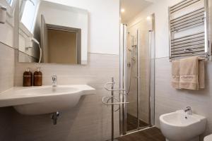 a white bathroom with a sink and a shower at Residence Elisabetta in Cesenatico +34 photos