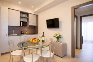a kitchen and dining room with a glass table and chairs at Residence Elisabetta in Cesenatico