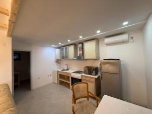 a small kitchen with a sink and a refrigerator at La Belle Saison in Briska Gora