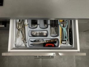 a drawer filled with utensils in a kitchen at La Moieciu pe Deal in Moieciu de Jos