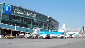 an airport with two airplanes parked in front of a building at B&B Il Ciliegio Druento in Druento