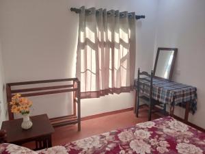 a bedroom with a bed and a mirror and a window at Breeze House in Hikkaduwa