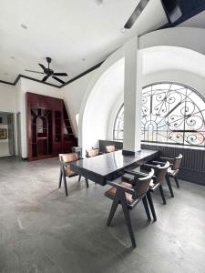 a dining room with a table and chairs and a window at SALA HOTEL HUE in Hue