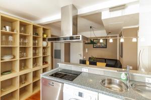a kitchen with a sink and a counter top at Red Fox Apartment in Garmisch-Partenkirchen +21 photos