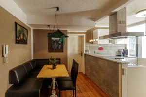 a living room with a table and a couch and a kitchen at Red Fox Apartment in Garmisch-Partenkirchen