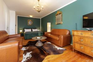 a living room with a couch and a bed at Red Fox Apartment in Garmisch-Partenkirchen