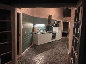 a kitchen with a sink and a stove at Herning, Sunds Lake Beautiful View & Spa 105 m2 in Sunds +11 photos