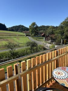 a balcony with a table and a view of a field at Gästezimmer Schupanez in Leutschach