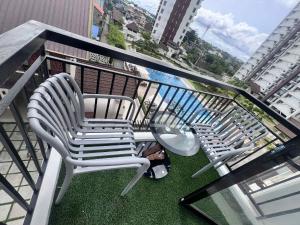 two chairs sitting on top of a balcony at AJB Royal Ocean Crest Mactan Cebu in Cebu City