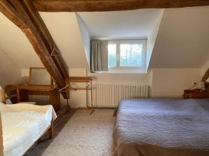 a bedroom with two beds and a window at Le relais Poyo in Arquian