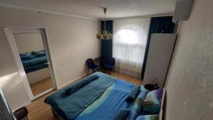 a bedroom with a bed and a large mirror at Hostel Amazing Ionika CenterCity in Chişinău +47 photos