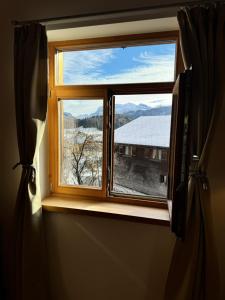 a window with a view of a snow covered mountain at Premium Apartment - großzügig & zentral wohnen in Schwarzenberg +52 photos