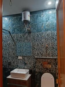 a bathroom with a sink and a toilet in it at Zora apartment in Rohtak +12 photos
