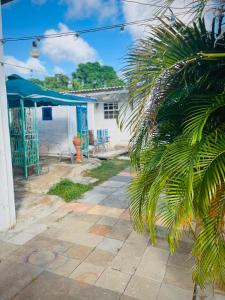 a patio with a table and chairs and a building at Blue Moon Cabin in Willemstad