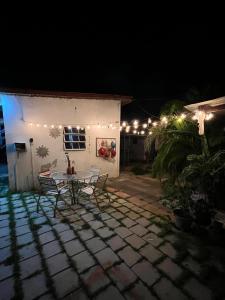a patio with a table and chairs at night at Blue Moon Cabin in Willemstad +3 photos